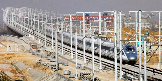 A CRH high-speed train zips in a test run in Zaozhuang, in east China's Shandong province, Friday, Dec. 3, 2010. The Chinese passenger train hit a record speed of 302 miles per hour (486 kilometers per hour) Friday during a test run of a yet-to-be opened link between Beijing and Shanghai, state media said.