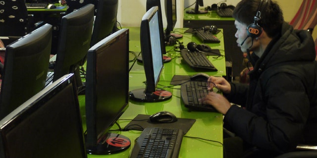 Surfing the Internet inside an Internet cafe in Dunhuang, in northwest China's Gansu province.