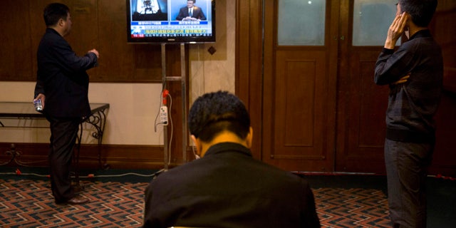 April 14, 2014: Relatives of Chinese passengers on board missing Malaysia Airlines Flight MH370 watch a live broadcast of a press conference by Angus Houston, the head of a joint agency coordinating the search off Australia's west coast, at a room reserved for family members in Beijing, China. (AP Photo/Ng Han Guan)