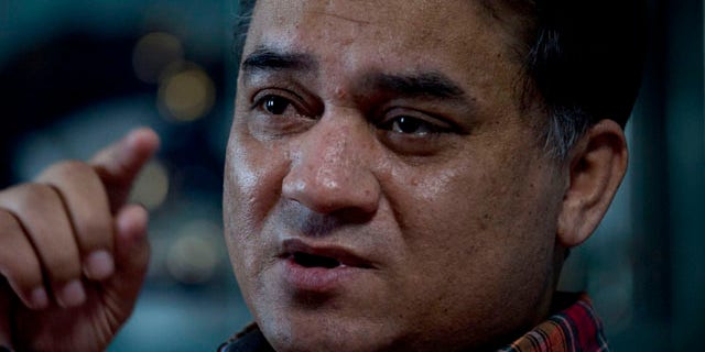 In this Feb. 4, 2013 photo, Ilham Tohti, an outspoken scholar of China's Turkic Uighur ethnic minority, speaks during an interview at his home in Beijing, China. (AP Photo/Andy Wong)