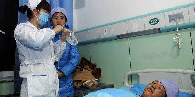 January 5, 2014: An injured woman receives medical treatment at a hospital in Xiji Town of Guyuan, northwest China's Ningxia region. China's Xinhua News Agency said Monday that 14 people were killed in a stampede at a mosque in the country’s north and 10 other people were injured in the incident in Guyuan. (AP Photo/Xinhua, Li Ran)