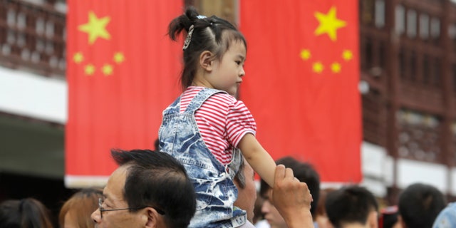 The Yuyuan garden, one of the most popular tourist destinations in town, is crowded by holiday goers on the first day of a week-long National Day holidays in Shanghai, China, Tuesday, Oct. 1, 2013. This year marks the 64th anniversary of the founding of the People's Republic of China. (AP Photo/Eugene Hoshiko)