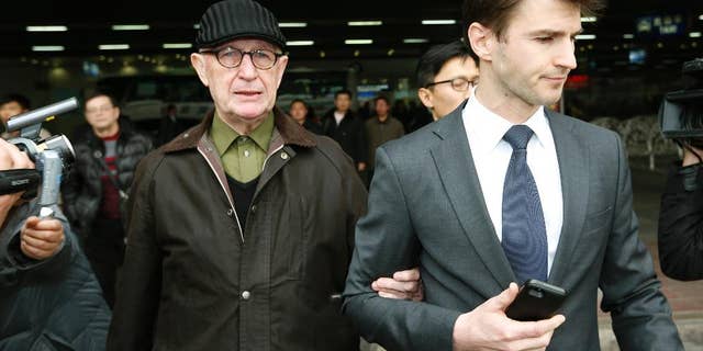 Australian missionary John Short, left, walks out from the airport terminal as he arrives at Beijing International Airport in Beijing, China, Monday, March 3, 2014. Short was deported from North Korea after he was detained for spreading Christianity in the country and apologized for his anti-state religious acts and requested forgiveness. (AP Photo/Vincent Thian)