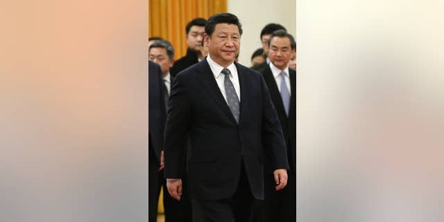 In this Jan. 7, 2015 photo, Chinese President Xi Jinping walks during a welcome ceremony for Venezuela's President Nicolas Maduro at the Great Hall of the People in Beijing, China. Xi's base salary is rising from about $13,600 to $22,300 a year under a recent general pay increase for public employees, state media reported Tuesday, Jan. 20. (AP Photo/Andy Wong)