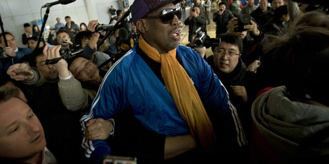 January 13, 2014: Former NBA basketball player Dennis Rodman is followed by journalists as he arrives at the Capital International Airport in Beijing from Pyongyang. A squad of former basketball stars led by Rodman had a friendly game with North Korean basketball players in Pyongyang. (AP Photo/Alexander F. Yuan)