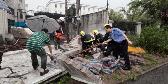 April 17: In this photo released by China's Xinhua News Agency, rescue team tries to save a resident trapped under a house which collapsed in a storm disaster in Foshan City, China's Guangdong Province.
