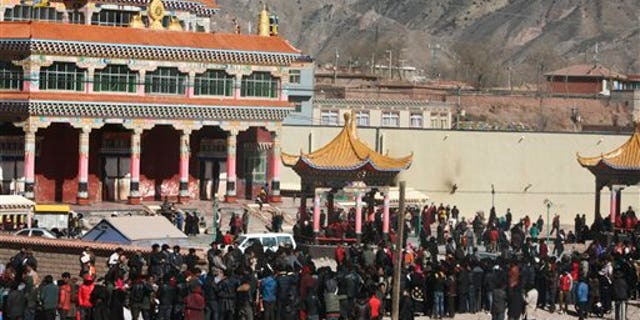 Feb. 8: Hundreds of Tibetans gather on the side of a main street in Nangqian county, China's Qinghai province.
