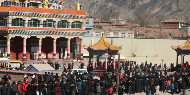 Feb. 8, 2012: Hundreds of Tibetans gather on the side of a main street in Nangqian county, China's Qinghai province.