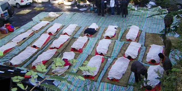 November 11: Relatives identify bodies of killed miners at the Sizhuang Coal Mine after a gas leak in Shizong county of Qujing city, in southwest China's Yunnan province.
