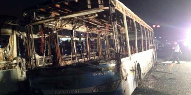 June 7, 2013: This image made with a mobile phone camera released by China's Xinhua News Agency shows the remains of an express bus that burst into flames in Xiamen, southeast China's Fujian Province. The express bus burst into flames on an elevated road in southeastern China on Friday, killing at least 30 people and injuring more than 30, state media reported.