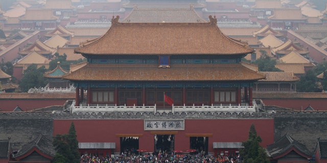 This Oct. 3, 2014 file photo shows tourists at the Forbidden City in Beijing, China.