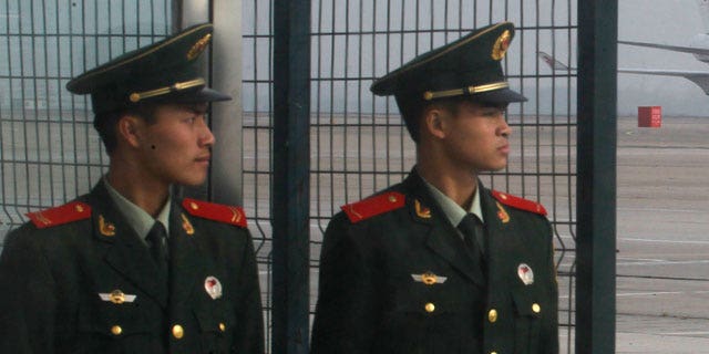 Oct. 28, 2011: Chinese paramilitary police officers stand guard as Chinese jetliner powered by biofuel lands after completing an inaugural flight from the airport in Beijing, China.