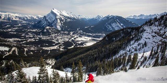 A snowboarder on the mountain in the Canadian Rockies, just 15 minutes from Banff, Alberta.