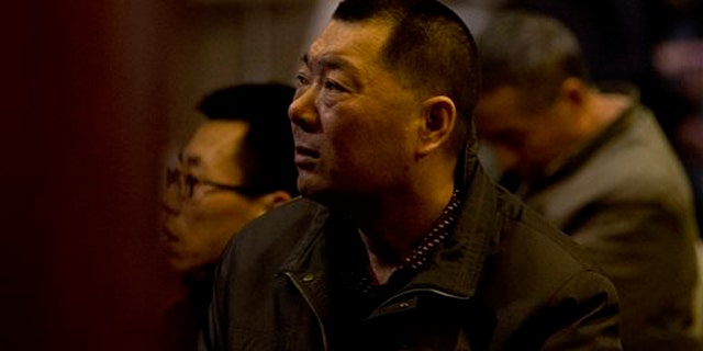 Relatives of Chinese passengers aboard the missing Malaysia Airlines Flight MH370 watch a TV news program about the plane as they wait for a news briefing by the Airlines' officials at a hotel ballroom in Beijing, China, Tuesday, March 18, 2014. Families of the passengers aboard the missing plane decided to organize a hunger strike to express their anger and disappointment at the handling of the situation by authorities. They decided on the action after a daily morning meeting with two officials from Malaysia Airlines. The plane has been missing since March 8, and contradictory information plus the fact there has been no sign of the plane has left family members frustrated. (AP Photo/Andy Wong)