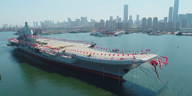 In this April 26, 2017, file photo released by China's Xinhua News Agency, China's newly-built aircraft carrier Liaoning is transferred from dry dock into the water at a launch ceremony at a shipyard in Dalian.