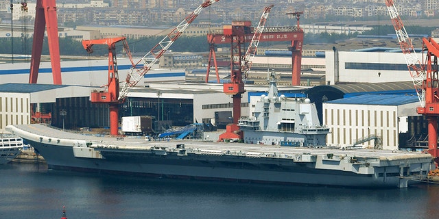 This May 9, 2018, photo released by China's Xinhua News Agency shows China's aircraft carrier Liaoning at a shipyard in Dalian.