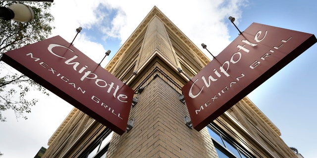 Signage hangs from a closed Chipotle restaurant in Portland, Ore., Monday, Nov. 2, 2015. Chipotle voluntarily closed down 43 of its locations in Washington and the Portland area as a precaution after an E. coli outbreak linked to six of its restaurants in the two states has sickened nearly two dozen people. (AP Photo/Don Ryan)