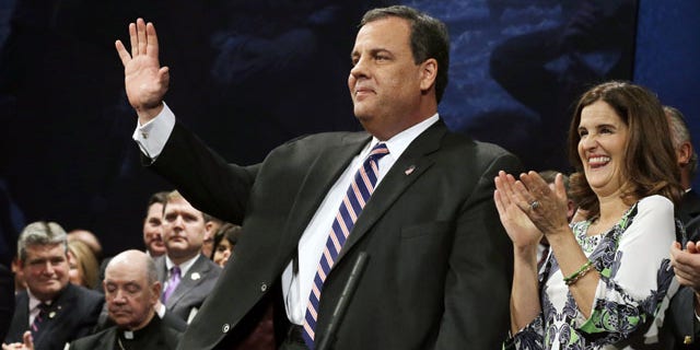 January 21, 2014: New Jersey Gov. Chris Christie waves as he stands with his wife Mary Pat Christie during a gathering for his swearing in for his second term in Trenton, N.J. (AP Photo)