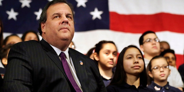 FILE - In this Jan. 7, 2014 file photo, New Jersey Gov. Chris Christie sits with students during a gathering at Colin Powell elementary school in heavily Hispanic Union City, N.J. after he ceremonially signed a bill that lowers tuition costs at public colleges for New Jersey students who lack lawful immigration status. A day after revelations that Christie's administration may have closed highway lanes to exact political retribution, the prospective Republican presidential candidate is faced with what may be the biggest test in his political career. (AP Photo/Mel Evans, File)