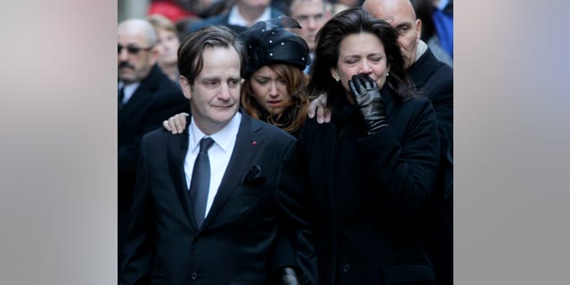 Jan. 5: Matthew Badger, left, and Madonna Badger, the parents of three children that were killed in a fire, react as their caskets are carried into a church during the funeral in New York.
