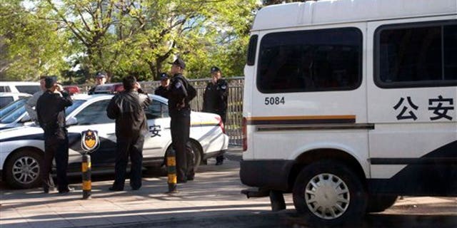 April 24: Chinese police officers and plain clothes watch an area where members of a unregistered church planned to hold Easter service in Beijing, China. Police stopped worshippers from gathering Sunday at a public plaza in the city's university district where they have been trying to meet every week since the congregation was evicted from its usual rented place of worship three weeks ago. At least a dozen congregants were detained. (AP)