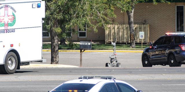A Dona Ana County bomb squad robot is deployed to examine a suspicious package at the First Presbyterian Church, Friday, Aug. 14, 2015, in Las Cruces, N.M. The device was found Friday morning by a groundskeeper at the church. Police haven't released any details about the device. The incident comes just weeks after the detonation of explosive devices outside two other Las Cruces churches. (Robin Zielinski/The Las Cruces Sun-News via AP) MANDATORY CREDIT