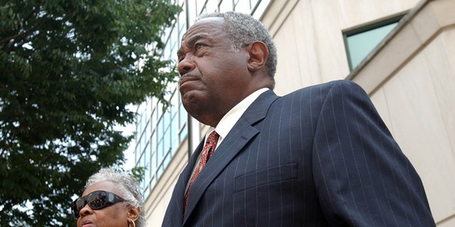 In this 2005 file photo, former Jefferson County Commissioner Chris McNair reacts outside of the Hugo L. Black Federal Courthouse in Birmingham, Ala., after being indicted on bribery, mail fraud and obstruction in the 1997 - 2003 Jefferson County sewer  operations.