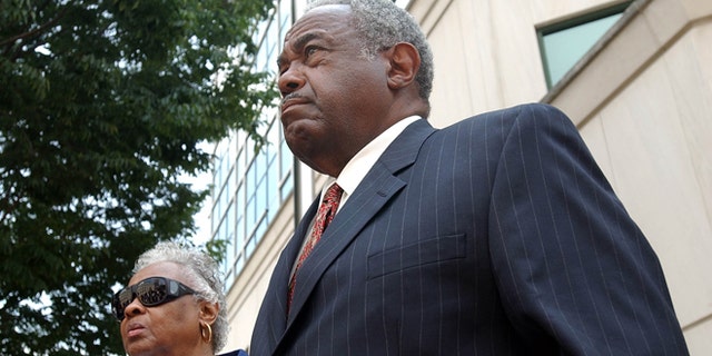 In this 2005 file photo, former Jefferson County Commissioner Chris McNair reacts outside of the Hugo L. Black Federal Courthouse in Birmingham, Ala., after being indicted on bribery, mail fraud and obstruction in the 1997 - 2003 Jefferson County sewer operations.