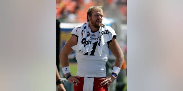Cincinnati quarterback Gunner Kiel stands on the sideline in the first half of an NCAA college football game against Miami, Saturday, Oct. 11, 2014, in Miami Gardens, Fla. Miami defeated Cincinnati 55-34. (AP Photo/Lynne Sladky)