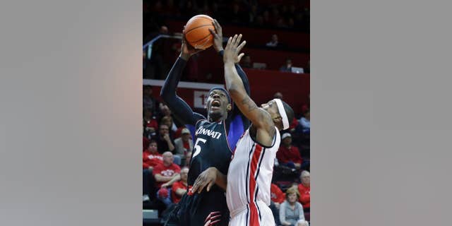 Cincinnati  forward Justin Jackson (5) takes a shot past Rutgers forward Wally Judge (33) during the first half of an NCAA college basketball game Saturday, March 8, 2014, in Piscataway, N.J. (AP Photo/Mel Evans)