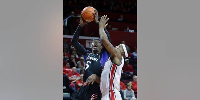 Cincinnati forward Justin Jackson (5) takes a shot past Rutgers forward Wally Judge (33) during the first half of an NCAA college basketball game Saturday, March 8, 2014, in Piscataway, N.J. (AP Photo/Mel Evans)
