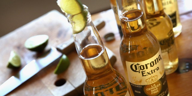 CHICAGO, IL - JUNE 07:  In this photo illustration, bottles of Corona beer are shown on June 7, 2013 in Chicago, Illinois.  Constellation Brands, one of the world's largest wine companies, is expected to become the third-largest beer supplier in the United State today with a $5.3 billion purchase of the U.S. distribution rights of Grupo Modelo beers from Anheuser Busch InBev. Corona Extra, brewed by Grupo Modelo, is the number one selling imported beer sold in the United States and the number six selling beer overall.  (Photo Illustration by Scott Olson/Getty Images)