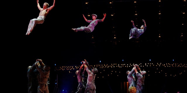 Cirque du Soleil performers appear to fly through the air a dress rehearsal at the Royal Albert Hall in London.