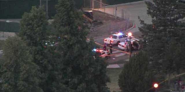 June 24, 2012: Police officers gather at the scene of a shooting at City Park in Denver.
