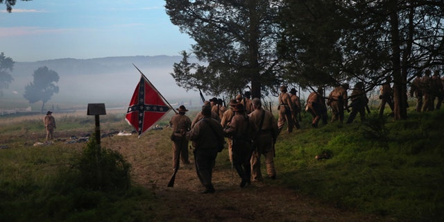 GETTYSBURG, PA - JUNE 29: Confederate Civil War re-enactors from Hood's Texas Brigade leave in defeat after an evening attack on Union troops as part of a three-day Battle of Gettysburg re-enactment on June 29, 2013 in Gettysburg, Pennsylvania. Some 8,000 re-enactors from the Blue Gray Alliance are participating in events marking the 150th anniversary of the July 1-3, 1863 Battle of Gettysburg. General Robert E. Lee's Army of Northern Virginia was defeated on the third day of the battle, considered the turning point in the American Civil War and a watershed moment in the nation's history. Union and Confederate armies suffered a combined total of some 46,000-51,000 casualties over three days, the highest of any battle the four-year war. (Photo by John Moore/Getty Images)