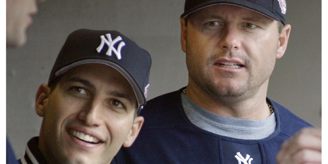 New York Yankees pitchers Andy Pettitte, left, and Roger Clemens talking with a teammate during a baseball game against the Detroit Tigers in Detroit.
