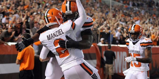 Aug 13, 2015; Cleveland, OH, USA; Cleveland Browns quarterback Johnny Manziel (2) celebrates his touchdown run with Cleveland Browns guard Karim Barton (63) during the second quarter against the Washington Redskins in a preseason NFL football game at FirstEnergy Stadium. Mandatory Credit: Ken Blaze-USA TODAY Sports