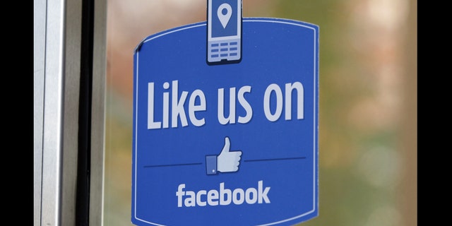 FILE - In this Dec. 13, 2011 file photo, a sign with Facebook's "Like" logo is posted at Facebook headquarters near the office for the company's User Operations Safety Team in Menlo Park, Calif. Celebrities, businesses and even the U.S. State Department have bought bogus Facebook likes, Twitter followers or YouTube viewers from offshore "click farms," where workers tap, tap, tap the thumbs up button, view videos or retweet comments to inflate social media numbers. (AP Photo/Paul Sakuma, File)