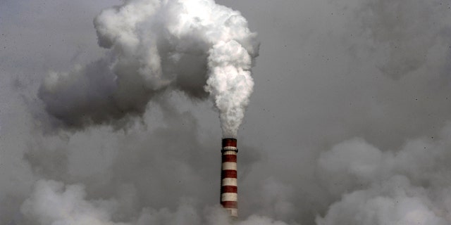 Smoke billows from the chimney of the cooling towers of a coal-fired power plant in Dadong, Shanxi province, China. Two weeks of United Nations climate talks in Bonn came up with a sketchy new draft for a deal to halt global warming, but some nations immediately raised concerns and observers said Friday, June 11, 2010, there is little substantial progress.