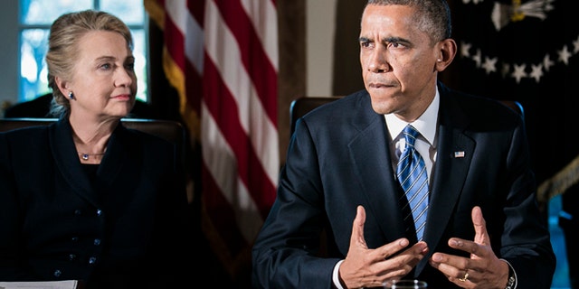 WASHINGTON, DC - NOVEMBER 28: (AFP OUT) U.S. President Barack Obama (R) speaks as U.S. Secretary of State Hillary Clinton listens at a cabinet meeting at the White House on November 28, 2012 in Washington, DC. The president met yesterday with small business owners and today with the chief executives of major corporations in ongoing talks about the looming fiscal cliff. (Photo by T.J. Kirkpatrick-Pool/Getty Images)