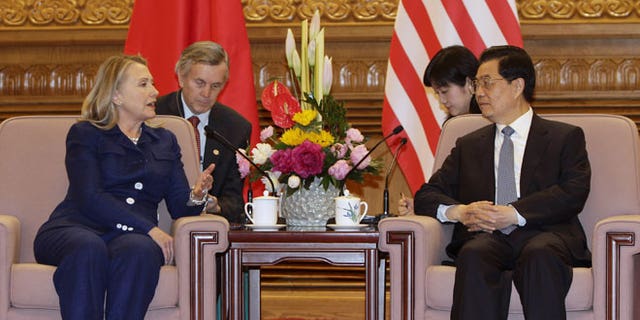 May 4, 2012: U.S. Secretary of State Hillary Rodham Clinton, left, talks to Chinese President Hu Jintao, right, during a meeting at the Great Hall of the People in Beijing.