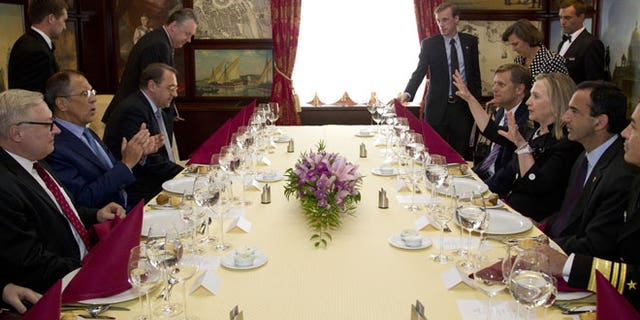 June 29, 2012: Secretary of State Hillary Rodham Clinton, center right, and Russian Foreign Minister Sergey Lavrov, center left, sit down for dinner in St. Petersburg, Russia.