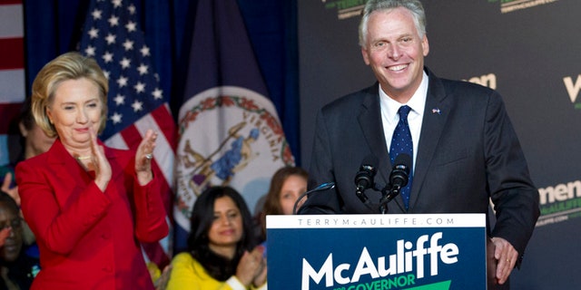 Saturday, Oct. 19, 2013.: Former Secretary of State Hillary Clinton applauds Virginia gubernatorial candidate, Democrat Terry McAuliffe, during a campaign rally, Women for Terry, at the State Theater in Falls Church, Va.