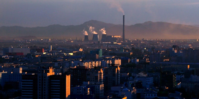 Smoke billows from the chimneys of a coal-burning power plant in Ulan Bator, Mongolia.