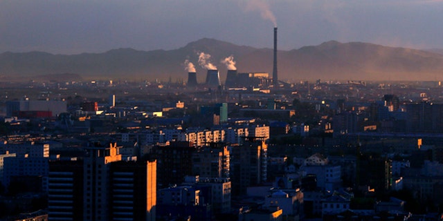 Smoke billows from the chimneys of a coal-burning power plant in Ulan Bator, Mongolia.