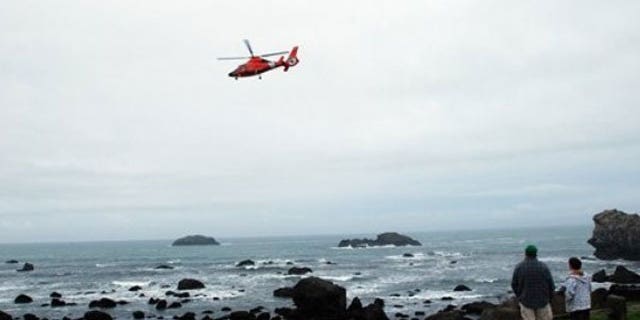 In this March 11, 2011 photo a Coast Guard MH-65 helicopter flies above Pebble Beach in Crescent City, Calif.