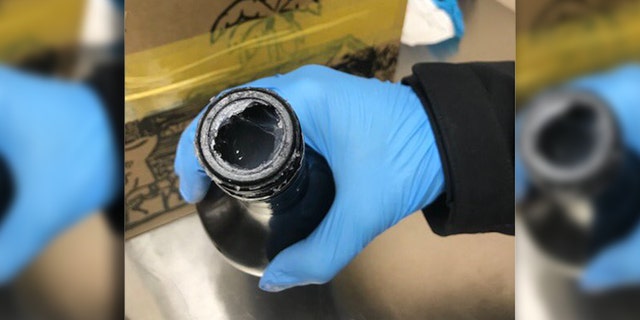 A woman from Jamaica allegedly tried to smuggle six pounds of cocaine into the United States in a liquor bottle.