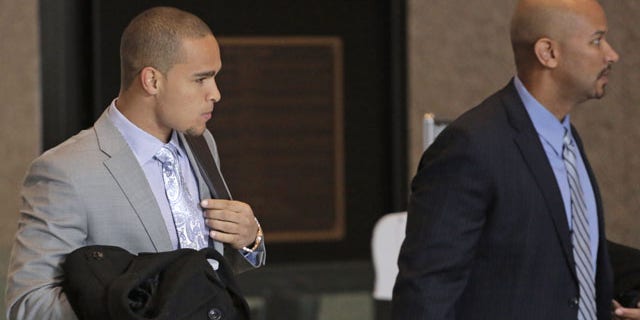 February 18, 2014: College Athletes Players Association designated president Ramogi Huma, right, and Northwestern University Wildcats' outgoing senior quarterback Kain Colter make their way to the beginning of three days of hearings before the National Labor Relations Board in Chicago. (AP)