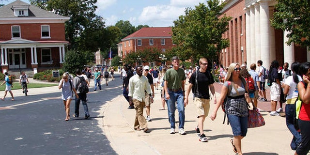 Students rush to class at the University of Mississippi, Sept. 1, 2010, in Oxford, Miss. Fiscal cuts from state funding are expected to affect all of the state's eight public colleges and may force faculty and staff layoffs, program eliminations and cuts in classes and services offered to students as well as raise various fees at the schools while they try to lessen the loss of funds. (AP Photo/Rogelio V. Solis)