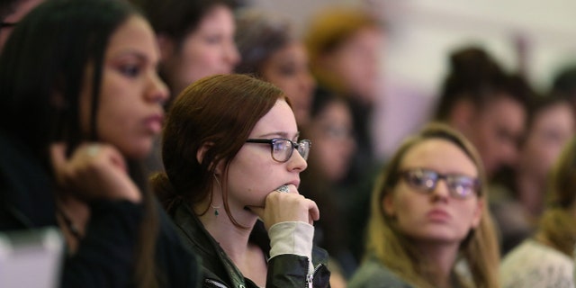 NEW YORK, NY - OCTOBER 19: Students watch as the Dalai Lama stands on stage at Hunter College where he received an honorary degree, a Doctor of Humane Letters, on October 19, 2012 in New York City. The Dalai Lama, the spiritual leader of Tibetan Buddhists and a Nobel Peace Prize winner, will also give a talk on the "Essence of Buddhism," October 21 at Lincoln Center. (Photo by Spencer Platt/Getty Images)